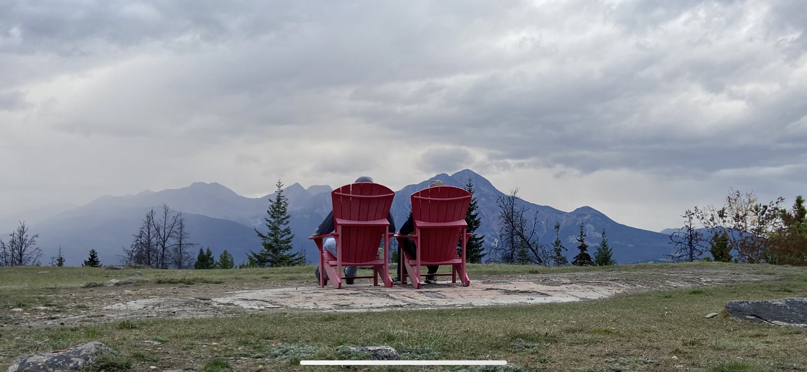 Two chairs facing the mountains in the Canadian Rockies