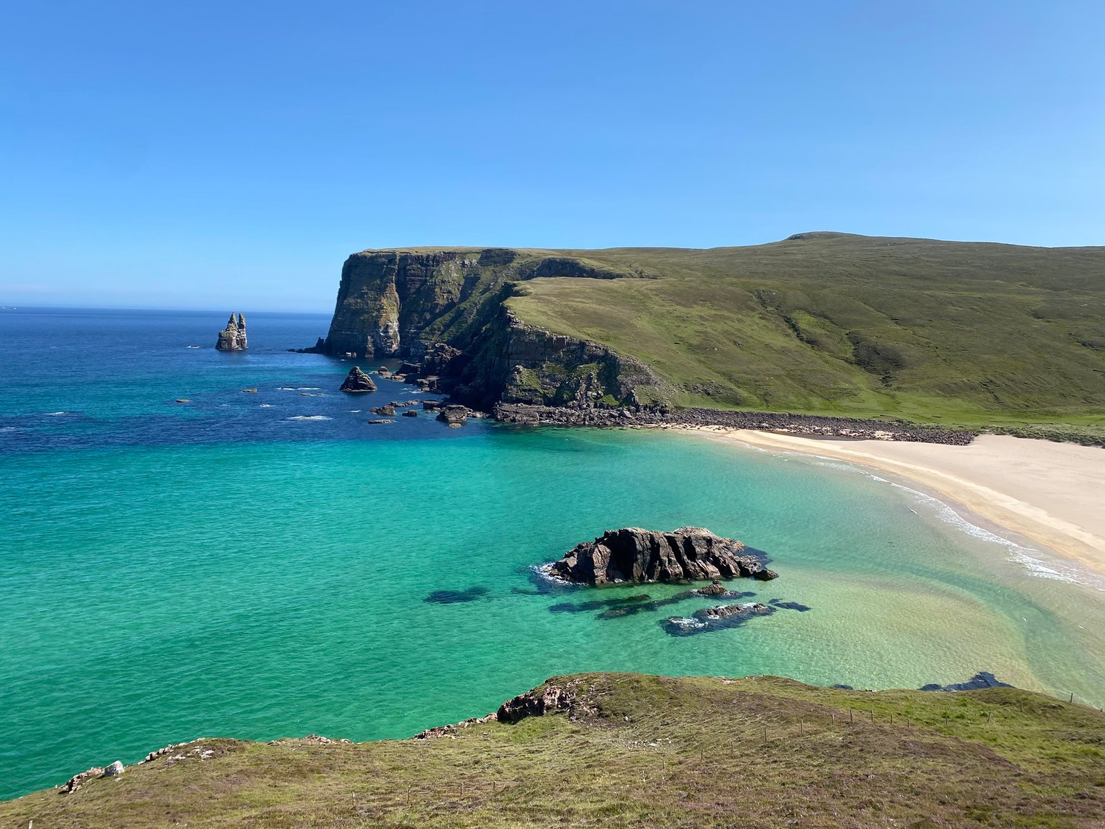 Turquoise water below the cliffs on the Cape Wrath Trail