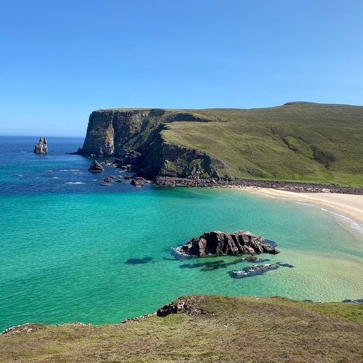 Turquoise water below the cliffs on the Cape Wrath Trail