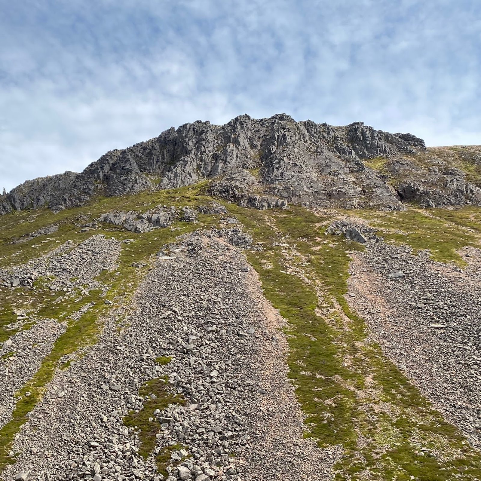 A rocky summit rising above the scree