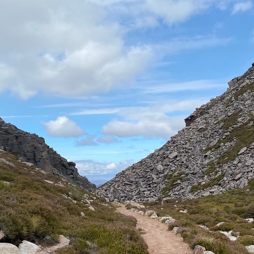 The path winding up through a boulder-strewn mountain pass