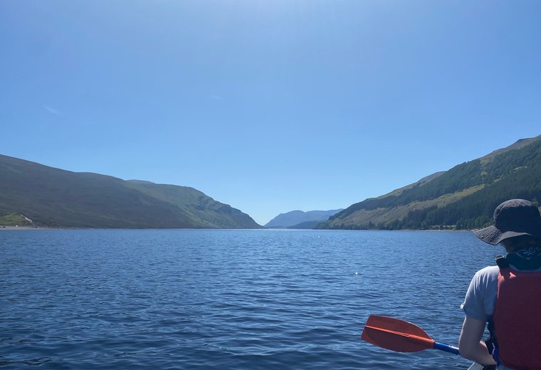 Still water and low hills under soft light