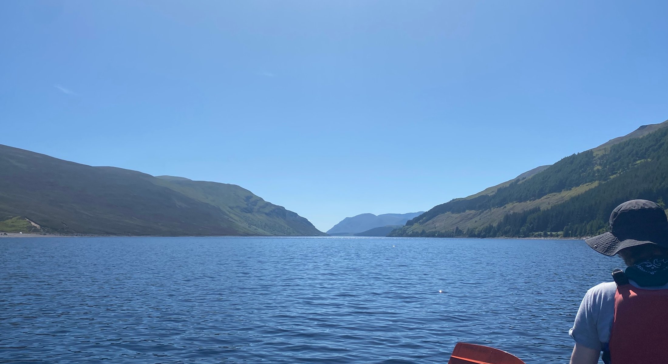 Still water and low hills under soft light